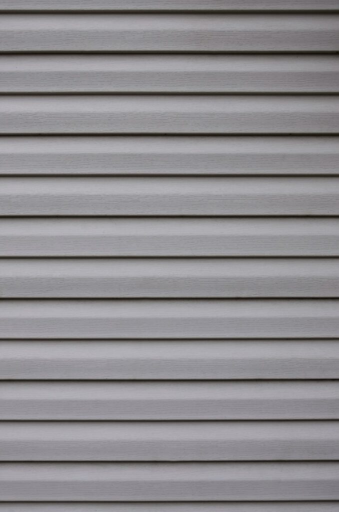 Siding, plastic panels texture closeup in the daytime outdoors
